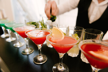 Whiskey-cola cocktail, mojito-cocktail, orange cocktail, strawberry cocktail in glass glasses with straws. Bar accessories