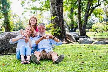 Happy family parent and child relax in weekend holiday lifestyle park outdoor nature background.