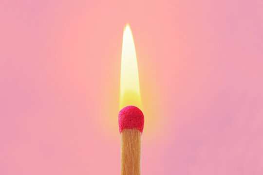 Pink match with flame on pink background - Concept of women and creative thinking