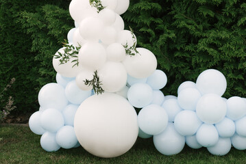 Decorations for holiday party. A lot of balloons blue and white colors. Round photo zone with balls