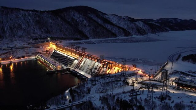 Hydroelectric dam on the river, filming at night with illumination