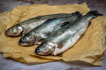 Three raw trout ready to be cooked.