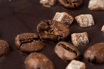 Close up of dark chocolate bar with coffee beans and candied fruit