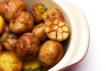 Baked potato in a clay pot isolated on white background