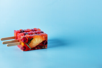 Natural Berry and Fruit Tea Flavour Popsicles on Blue Background Summer Refreshing Delicious and Healthy Treat or Desserts Popsicle for Tea Horizontal