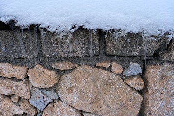 Snowy wall. Snow falling on the wall.