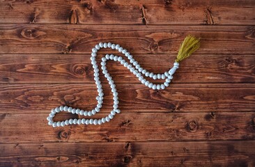 Rosary. Rosary of Islamic faith on wooden background.