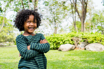 child little boy happy smile and laugh hair style afro relax in weekend holiday lifestyle park.