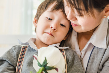 child little boy and mom with white rose to the mother ,Mother's day, People family learning...