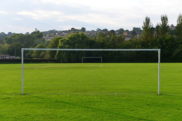 Fototapeta na wymiar Football or Soccer Goal Post on a Pitch in a Town Park