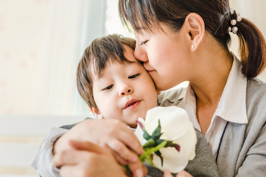 child little boy and mom with white rose to the mother ,Mother's day, People family learning lifestyle concept.