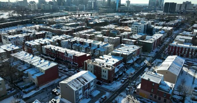 American city in winter snow. Aerial tilt up reveals urban cityscape skyline. Residential inner city shot.