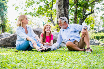 Fototapeta premium Happy family parent and child relax in weekend holiday lifestyle park outdoor nature background.