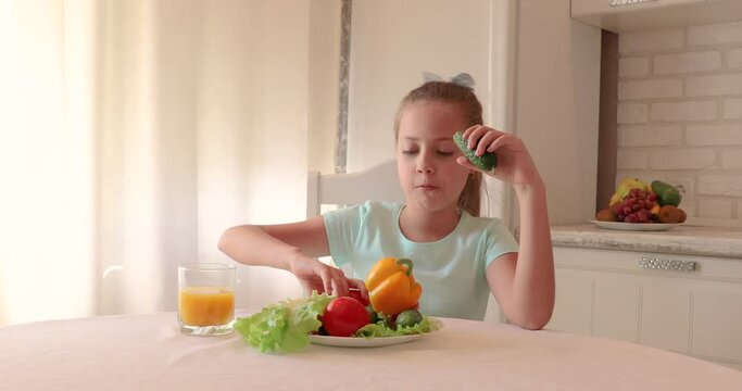 little girl in the kitchen. the child loves vegetables. healthy food concept. vitamins for a child