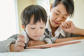 little kids boy cute schoolboy fun and enjoying playing and using digital tablet ,People family learning lifestyle concept.