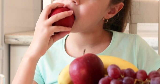 the child eats fruits with pleasure. The girl eats healthy food. the concept of children's health