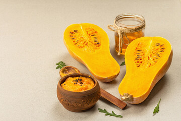 Halves of raw pumpkin with butternut squash puree, honey and fresh herbs. Assortment ingredients