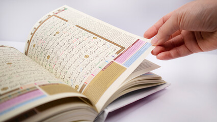 hand  fliping one sheet of holy quran