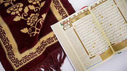 holy quran with indonesian translate on a prayer matt