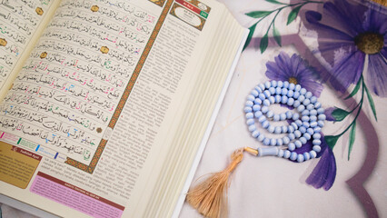 holy quran with indonesian translate with tasbih on a prayer matt