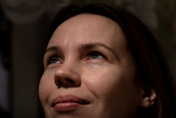 A middle-aged woman smiles. Attractive woman in her forties without make-up. Close-up.