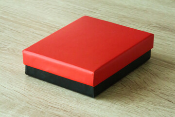 Mockup red and black box on wood table background