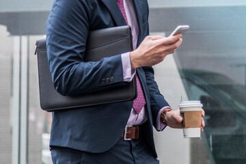 Black leather business padfolio portfolio folder held by man in business suit - Powered by Adobe