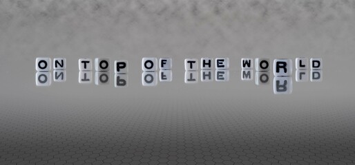 on top of the world word or concept represented by black and white letter cubes on a grey horizon background stretching to infinity