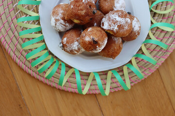 Traditional italian Fritters called Frittelle on a plate with Carnival decorations