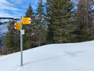 Hiking markings and orientation signs with signposts for navigating in the idyllic winter ambience of the Alpstein massif in the Swiss Alps - Schw&auml;galp mountain pass, Switzerland (Schweiz)