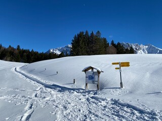 Hiking markings and orientation signs with signposts for navigating in the idyllic winter ambience of the Alpstein massif in the Swiss Alps - Schwägalp mountain pass, Switzerland (Schweiz)