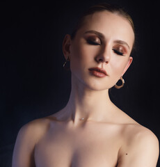 Fototapeta premium Close-up portrait of young woman with smoky eyes makeup.