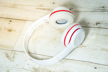 wireless headphones red white on wooden floor