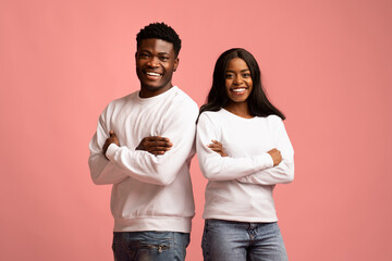 Confident young black man and woman smiling at camera