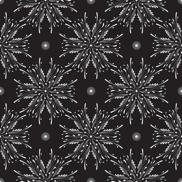 Seamless pattern with white abstract flowers on a black background for packaging, fabrics, backgrounds and other products.