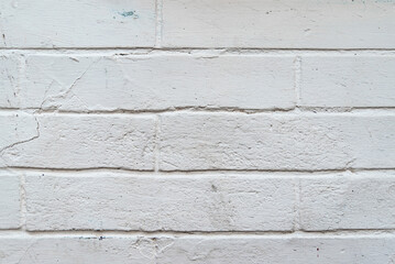 Texture of a brick wall painted with white paint