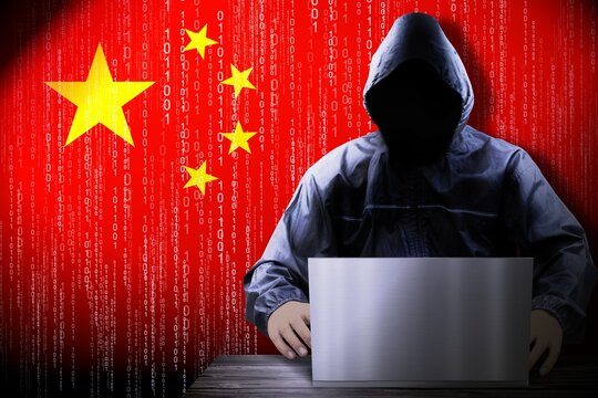 Anonymous hooded hacker, flag of China, binary code - cyber attack concept