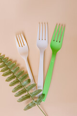 Disposable plastic cutlery on peach background