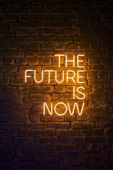 neon glowing inscription on the wall the future is now - obrazy, fototapety, plakaty
