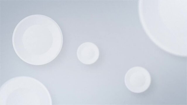 White circles in the form of pills bounce on a white background. Copy space white backdrop