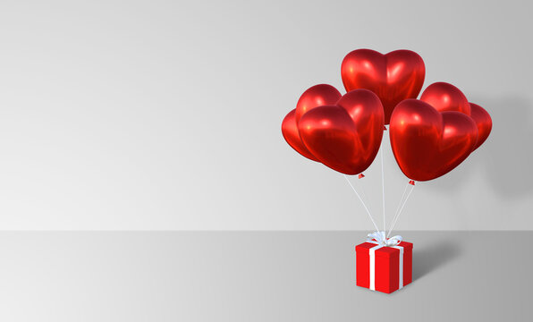 Heart shape red metalic air balloon hanging with red present box with white ribbon for Valentine's Day on white background, 3D rendering image