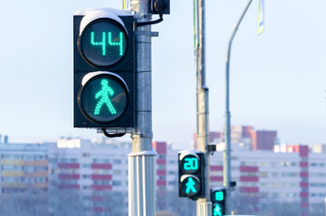 Three traffic lights for pedestrians show the time left to cross the road