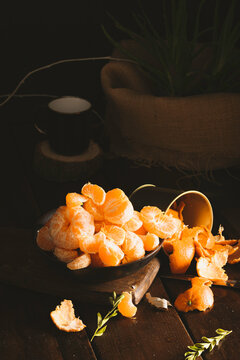 Juicy tangerines falling on dark backgorund