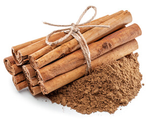 Cinnamon dried bark strips and cinnamon powder, sweet-smelling brown substance used in cooking, isolated on white background.