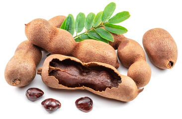 Ripe tamarind fruit, leaves and some tamarind seeds isolated on white background.