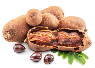 Ripe tamarind fruit, leaves and some tamarind seeds isolated on white background.