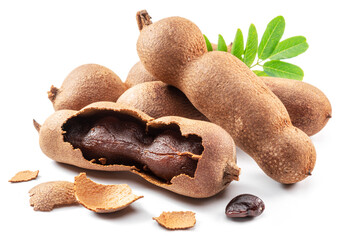 Ripe tamarind fruit, leaves and some tamarind seeds isolated on white background.