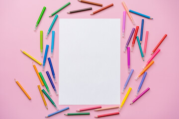 multi-colored felt-tip pens on a pink background, space for text, top view, blank sheet