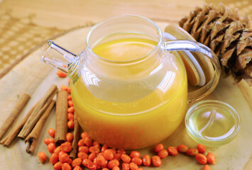 tea kettle transparent glass on a beautiful background of hay, next to pineapple, mint, orange, honey, fruit tea 