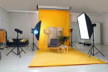 Fototapeta na wymiar Stylish furniture in photo studio with professional equipment